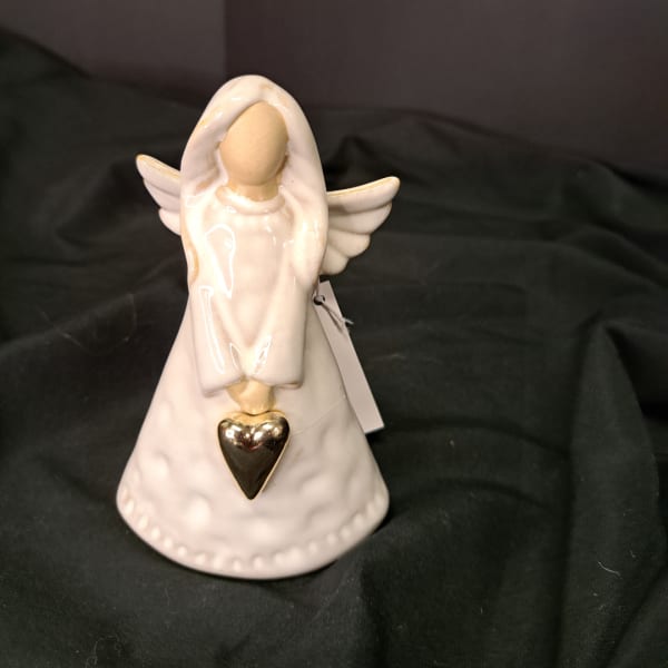 Ceramic angel figurine with a gold heart pendant