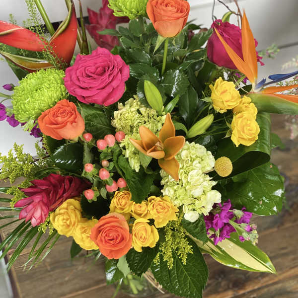 Colorful mixed bouquet with roses, orchids, and green mums