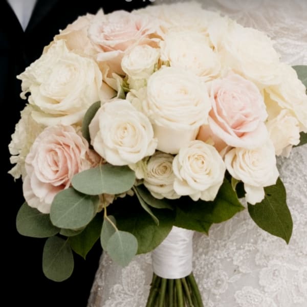 Bouquet of pale pink and white roses with eucalyptus greenery
