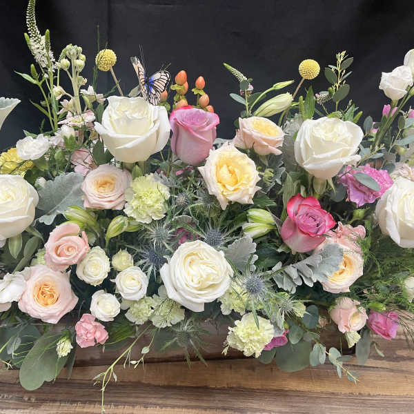 Large mixed bouquet of white, pink, and peach roses with assorted blooms