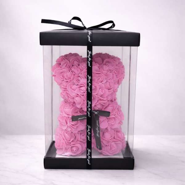 Pink rose teddy bear in a clear gift box with a black ribbon