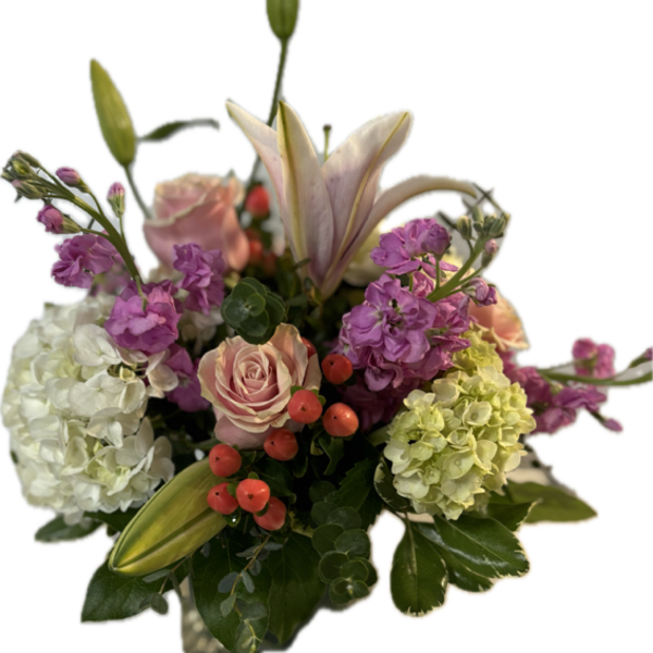 Pink lilies, roses, hydrangeas, and purple blooms in a bouquet