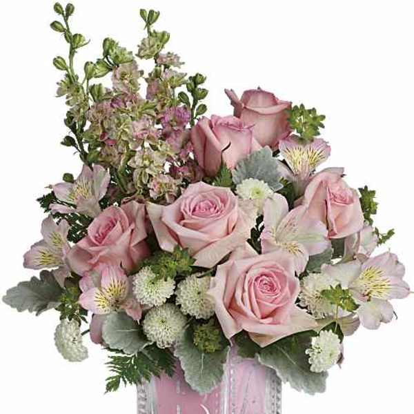 Pink roses and alstroemeria in a clear square vase
