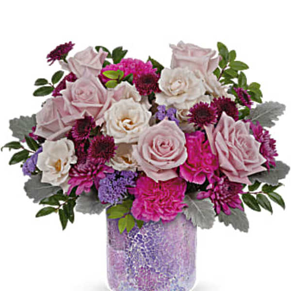 Pink and white rose bouquet in a purple glass vase