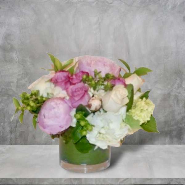 Pink and white floral arrangement in a clear glass vase