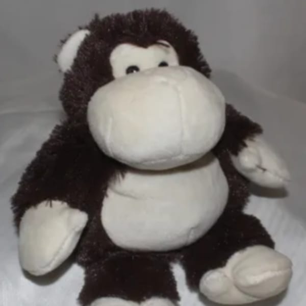 Plush monkey toy with a white face and belly