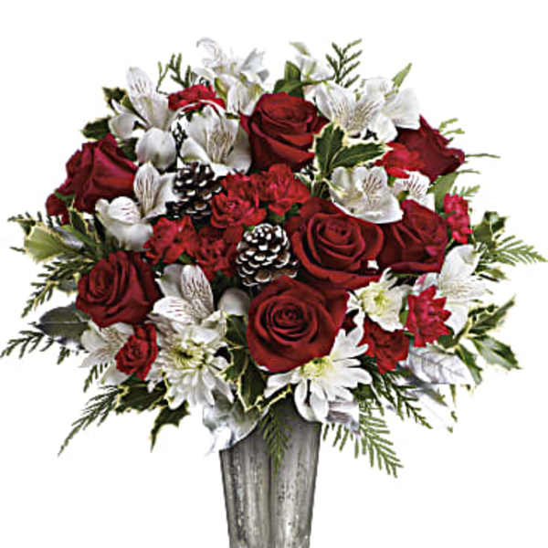Red roses and white flowers in a silver vase
