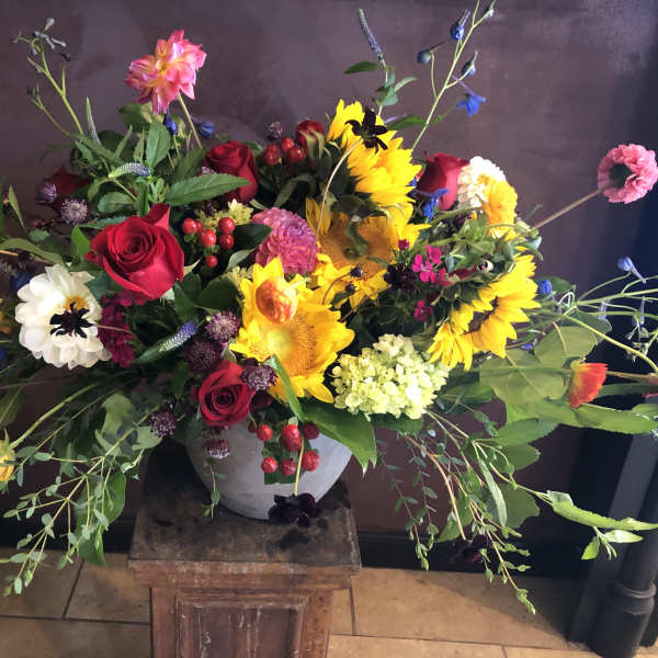 Colorful mixed flower arrangement in a gray vase