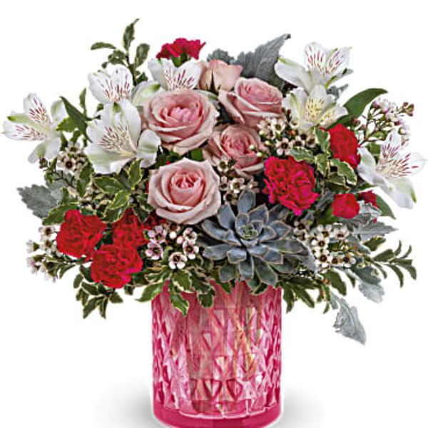 Pink and red rose bouquet in a pink glass vase
