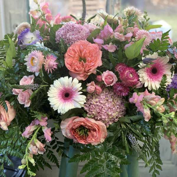 Mixed pink and white flowers in a lush bouquet