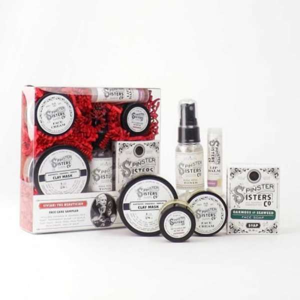 Skincare gift set with jars, tubes, and a spray bottle in a box