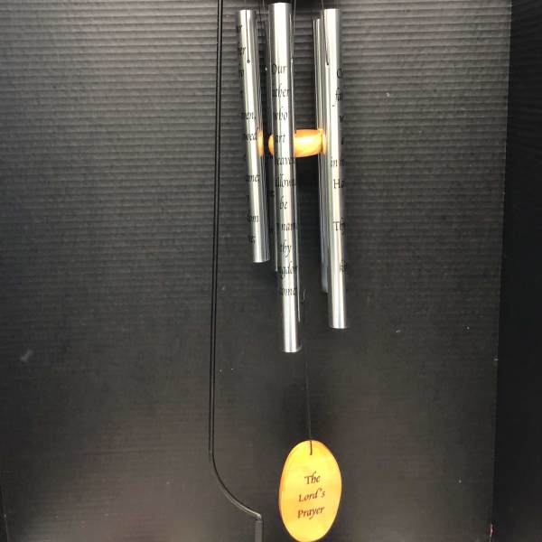 Hanging silver wind chime with orange accents and engraved prayer text