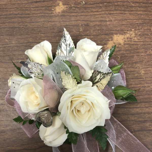 Small bouquet of white roses with pink ribbon and silver accents