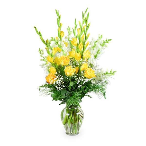 Yellow floral arrangement in a clear glass vase