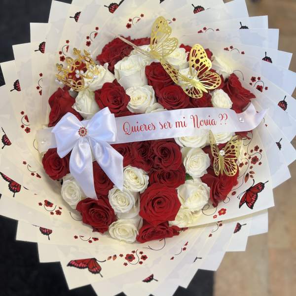 Red and white rose bouquet with butterfly decorations and a ribbon