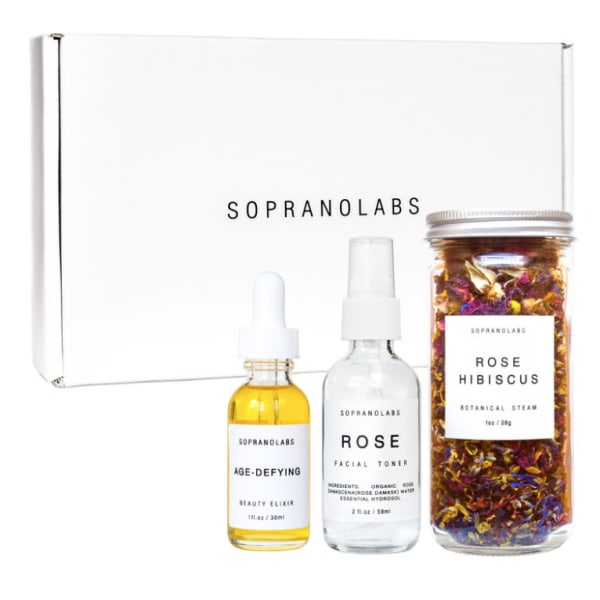 Skincare gift set with two dropper bottles and a jar of dried botanicals