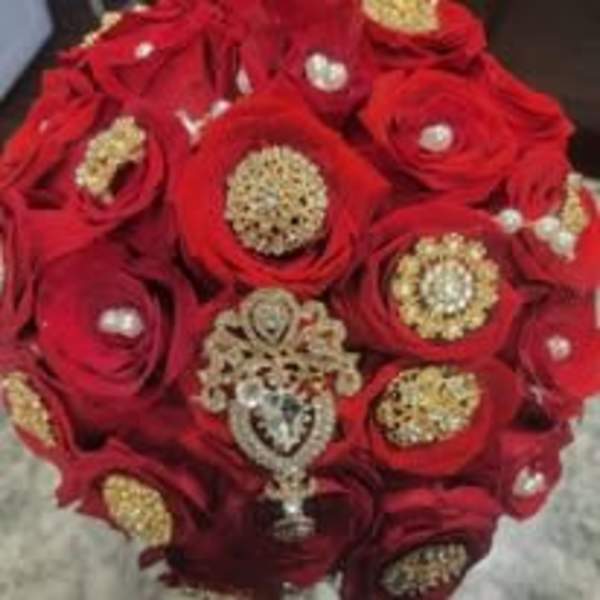 Red rose bouquet with jeweled centers and a pendant accent