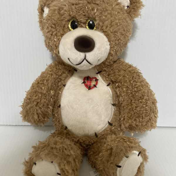 Brown teddy bear plush with a cream belly and heart patch