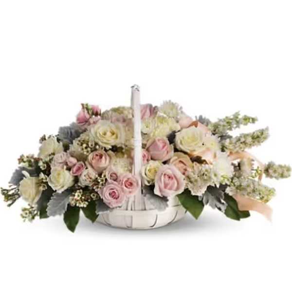 Low floral basket with pink and cream roses and a white handle