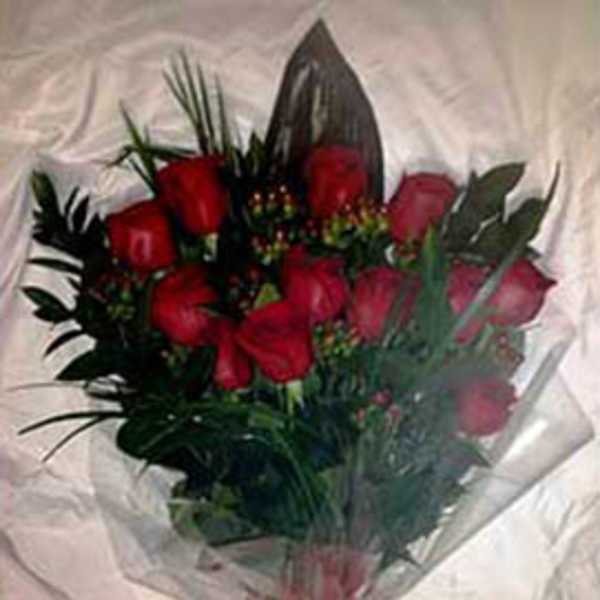 Hand-tied bouquet of red roses wrapped in clear cellophane with a red bow