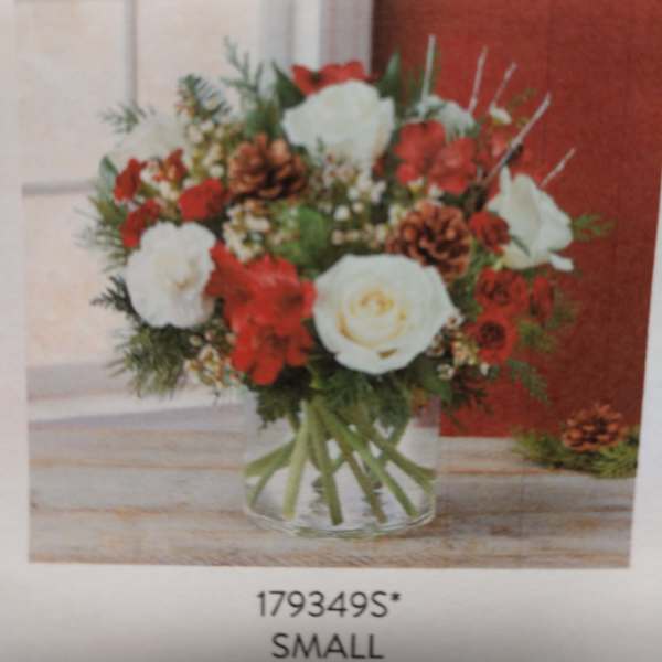 Red and white flower arrangement in a clear glass vase