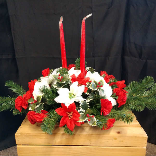 Red and white floral centerpiece with two tall red candles