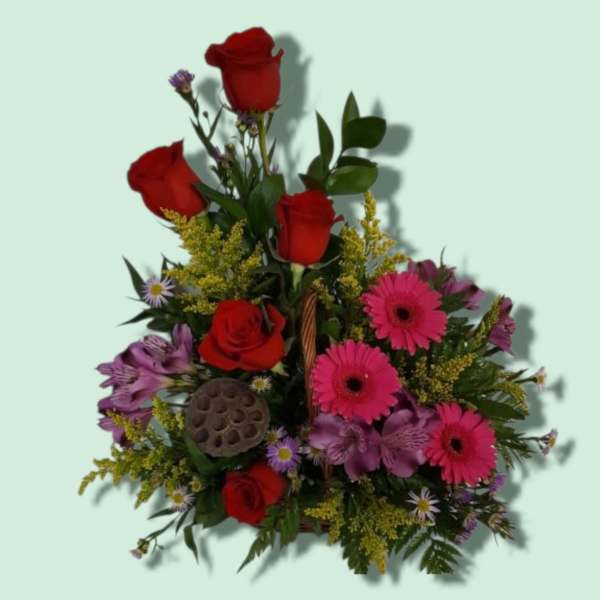 Mixed bouquet with red roses, pink gerbera daisies, and purple flowers