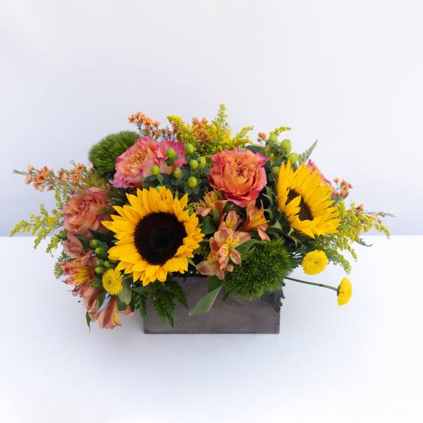 Sunflowers and peach roses in a rectangular box