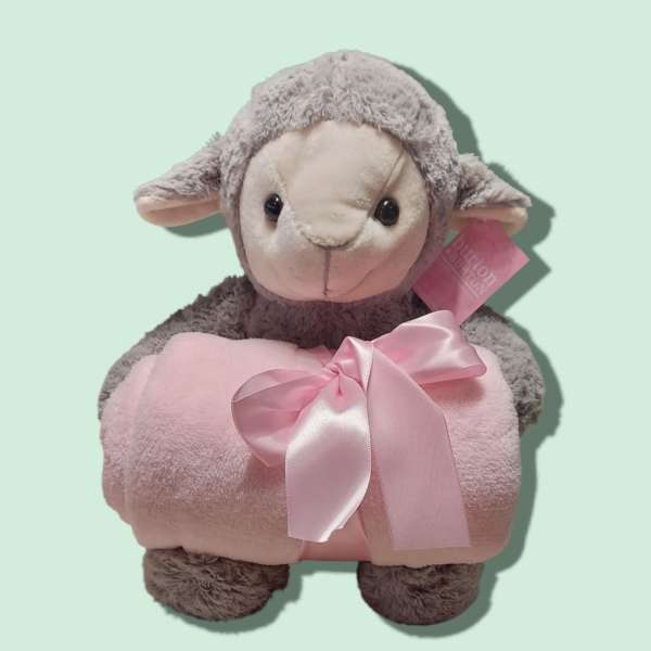 Plush lamb holding a pink blanket with a satin bow