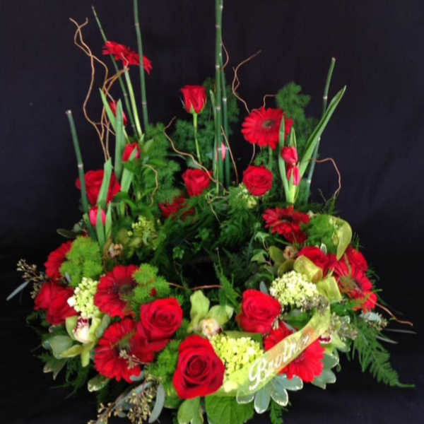 Large red floral arrangement with roses and gerbera daisies