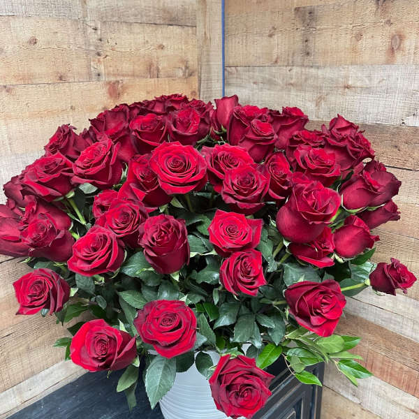 Bouquet of red roses in a white vase