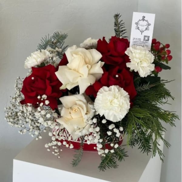 Red and white rose bouquet with carnations and evergreen accents