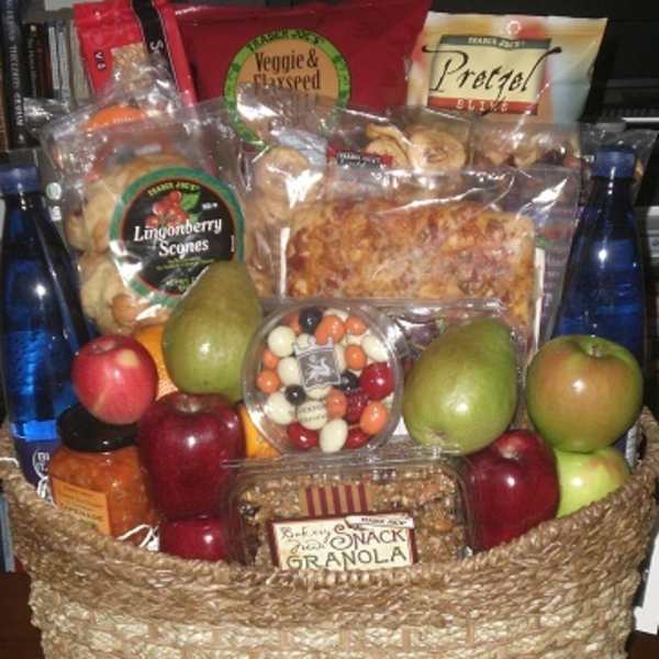 Gift basket with fruit, snacks, and bottled drinks