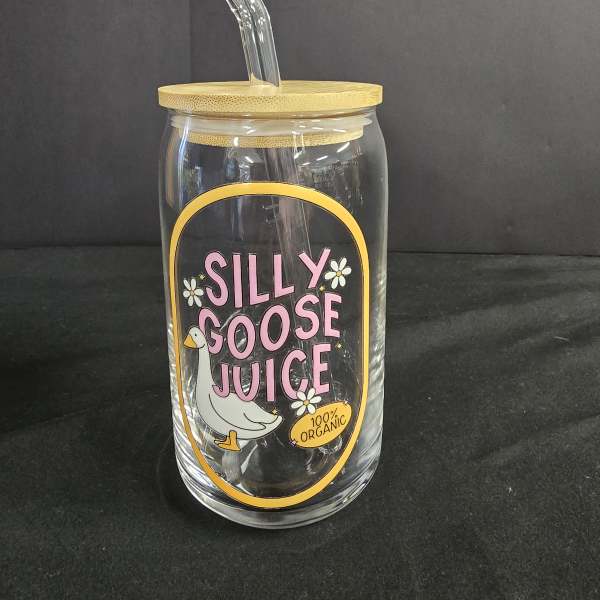 Clear glass tumbler with a bamboo lid and glass straw