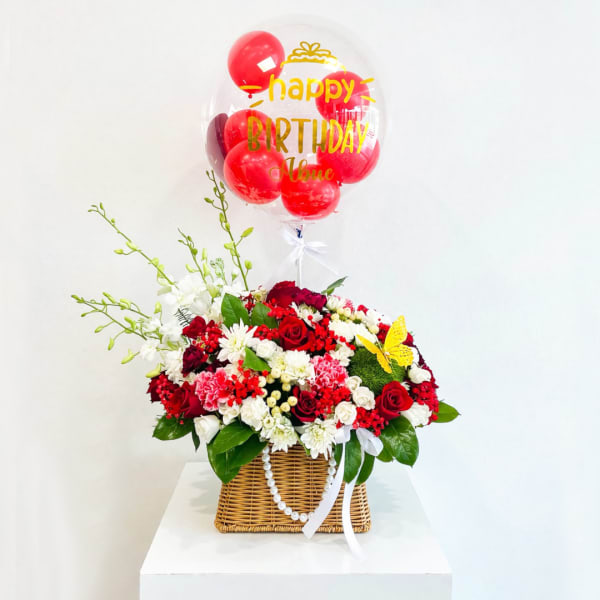 Red and white flower basket with a birthday balloon