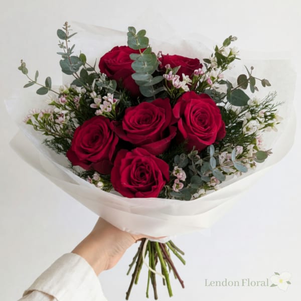 Bouquet of red roses with small pink and white filler flowers