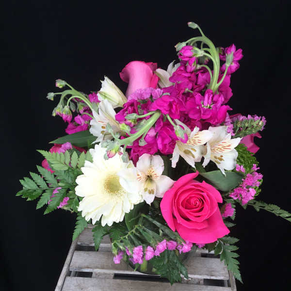 Pink and white mixed flower bouquet in a glass vase