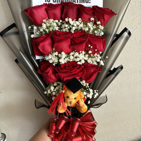 Bouquet of red roses with baby’s breath, graduation sign, and teddy bear