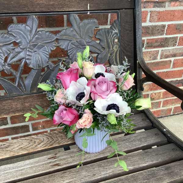 Pink and white flower arrangement in a ribbed vase