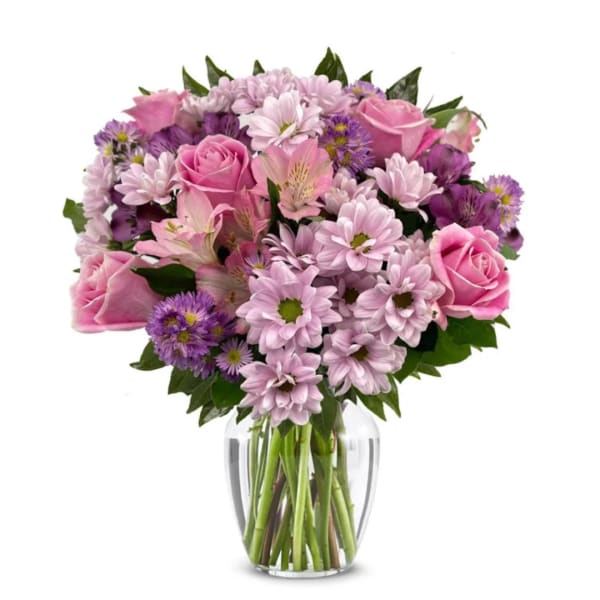 Pink and purple mixed bouquet in a clear glass vase