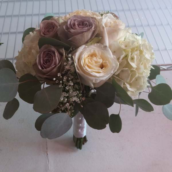 Bouquet of blush and cream roses with hydrangeas and eucalyptus