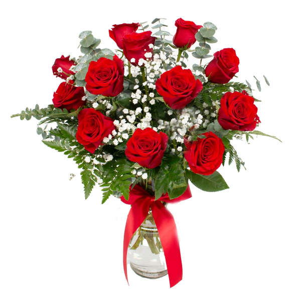 Red roses in a glass vase with baby's breath and a red ribbon