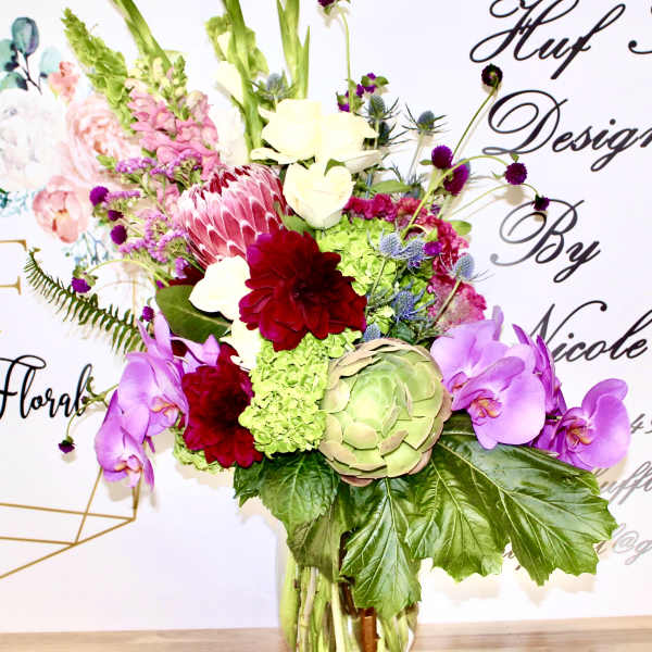 Colorful mixed flower arrangement in a clear glass vase
