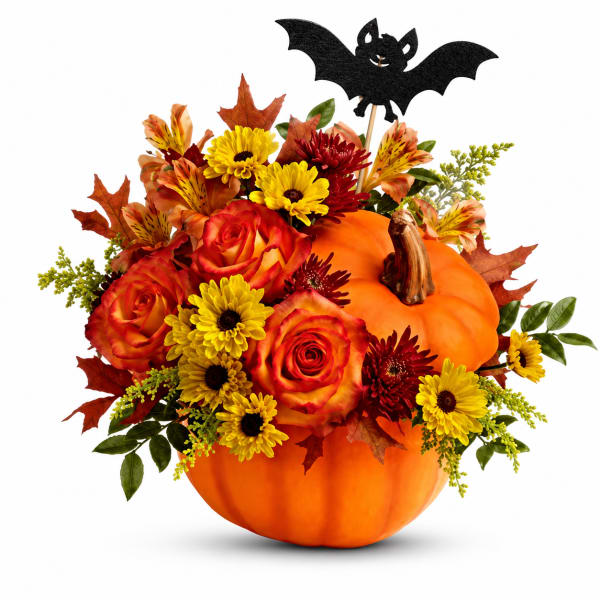Pumpkin arrangement with roses and daisies, topped with a bat decoration