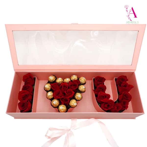 Pink gift box with red roses and Ferrero Rocher chocolates arranged in letters