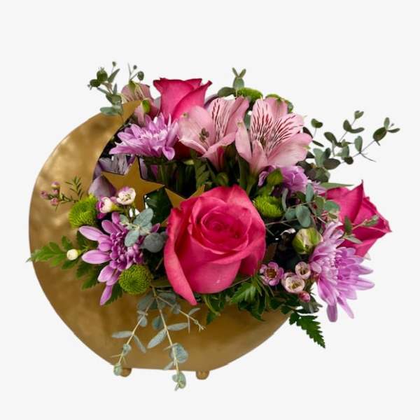 Pink and purple bouquet with roses and daisies in a gold wrap