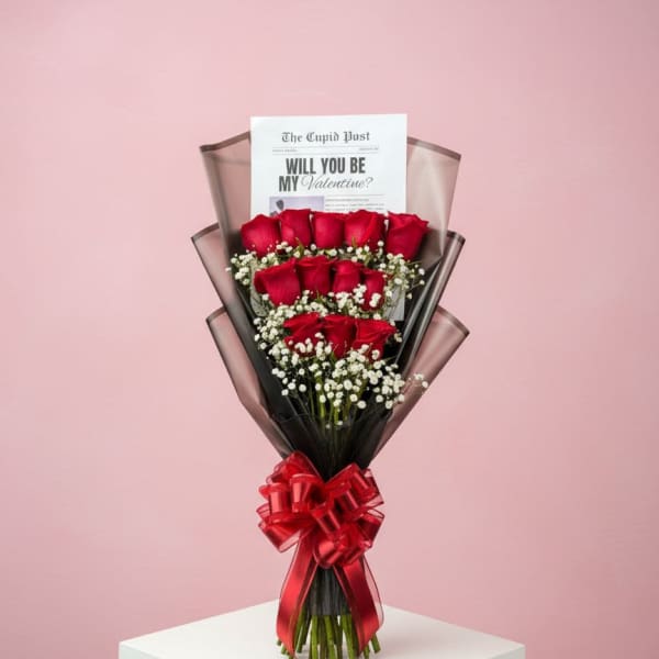Bouquet of red roses with a Valentine card and red ribbon