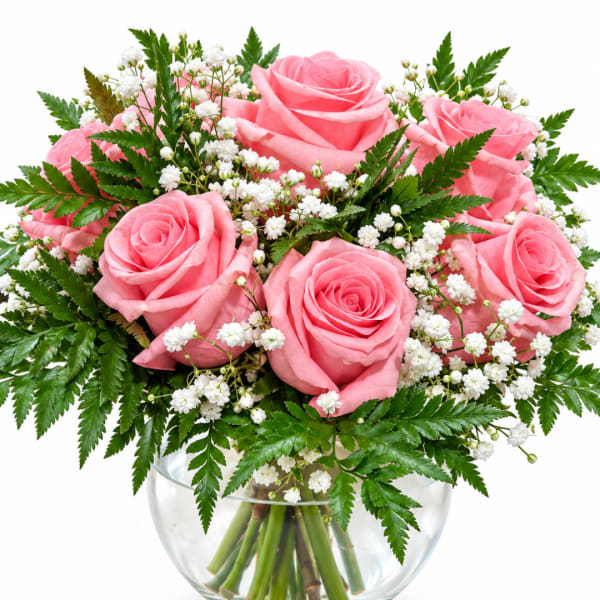 Pink roses with white baby's breath in a clear glass vase
