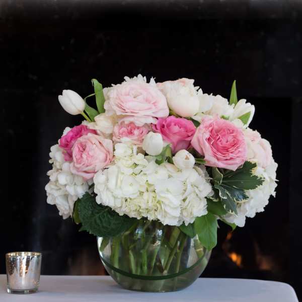 Pink and white rose bouquet in a clear glass vase
