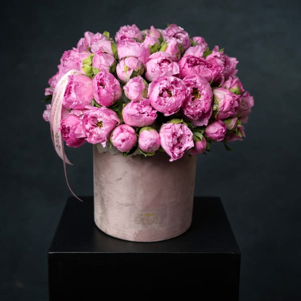 Pink peony bouquet in a blush cylindrical box with ribbon